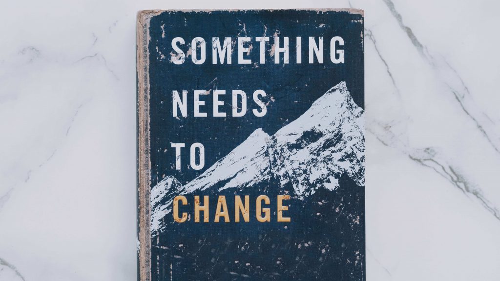 книга с надпис Something needs to change